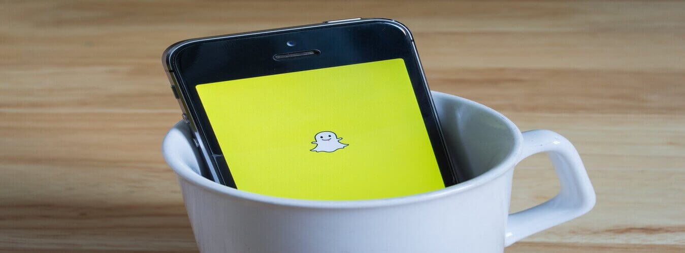 Snapchat on phone logo-min